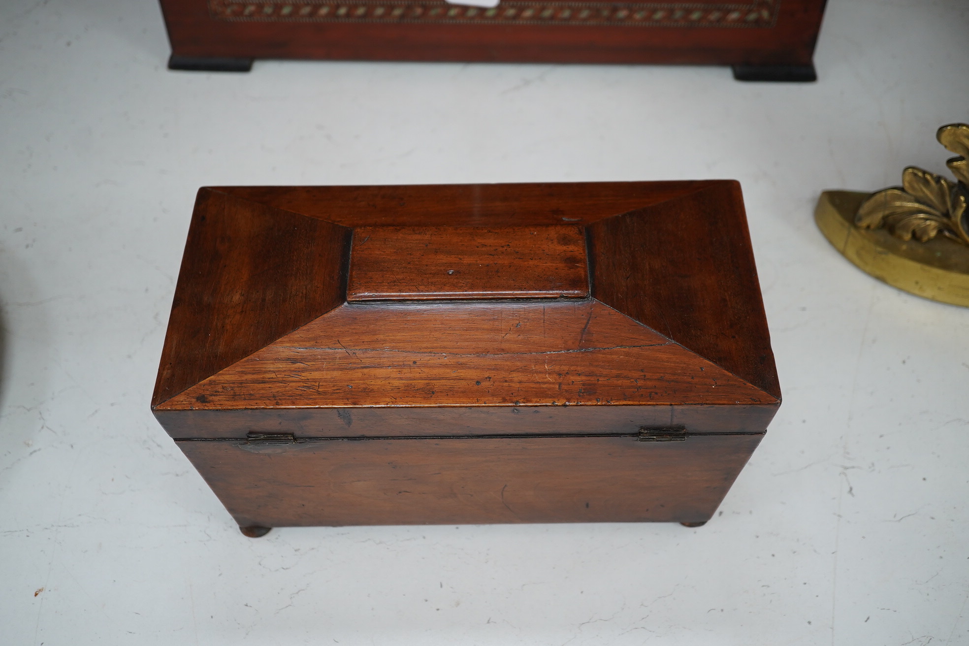 A Victorian mahogany sarcophagus shaped tea caddy with mother of pearl inlaid escutcheon, 28cm. Condition - fair